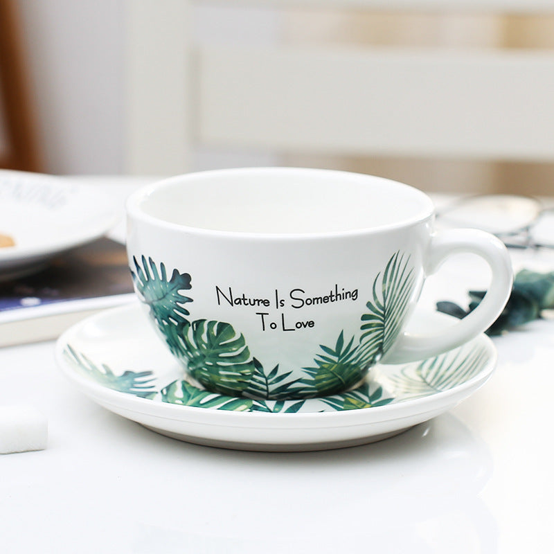 Embossed porcelain latte coffee cup with nature-themed design.