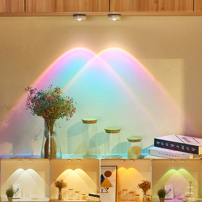 Wireless LED lights under furniture in a kitchen setting, emitting colorful sunset effects on the wall.